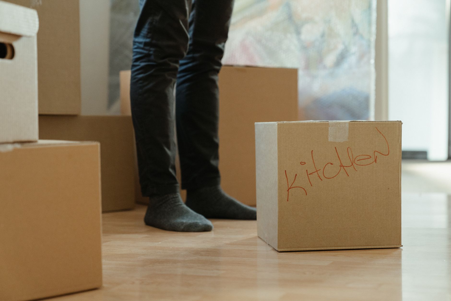 Packed cardboard boxes labelled for the kitchen in a new home