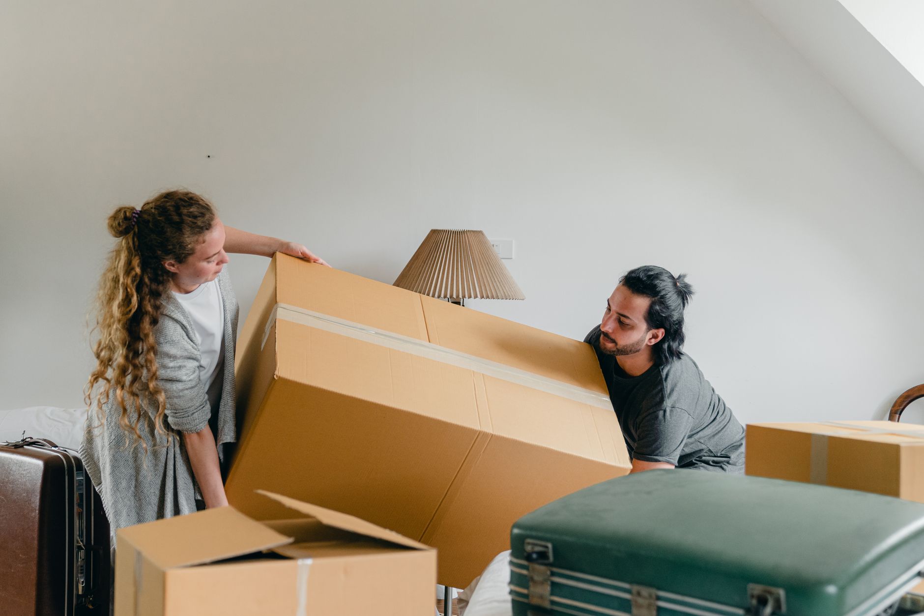Students carrying packed boxes during a move