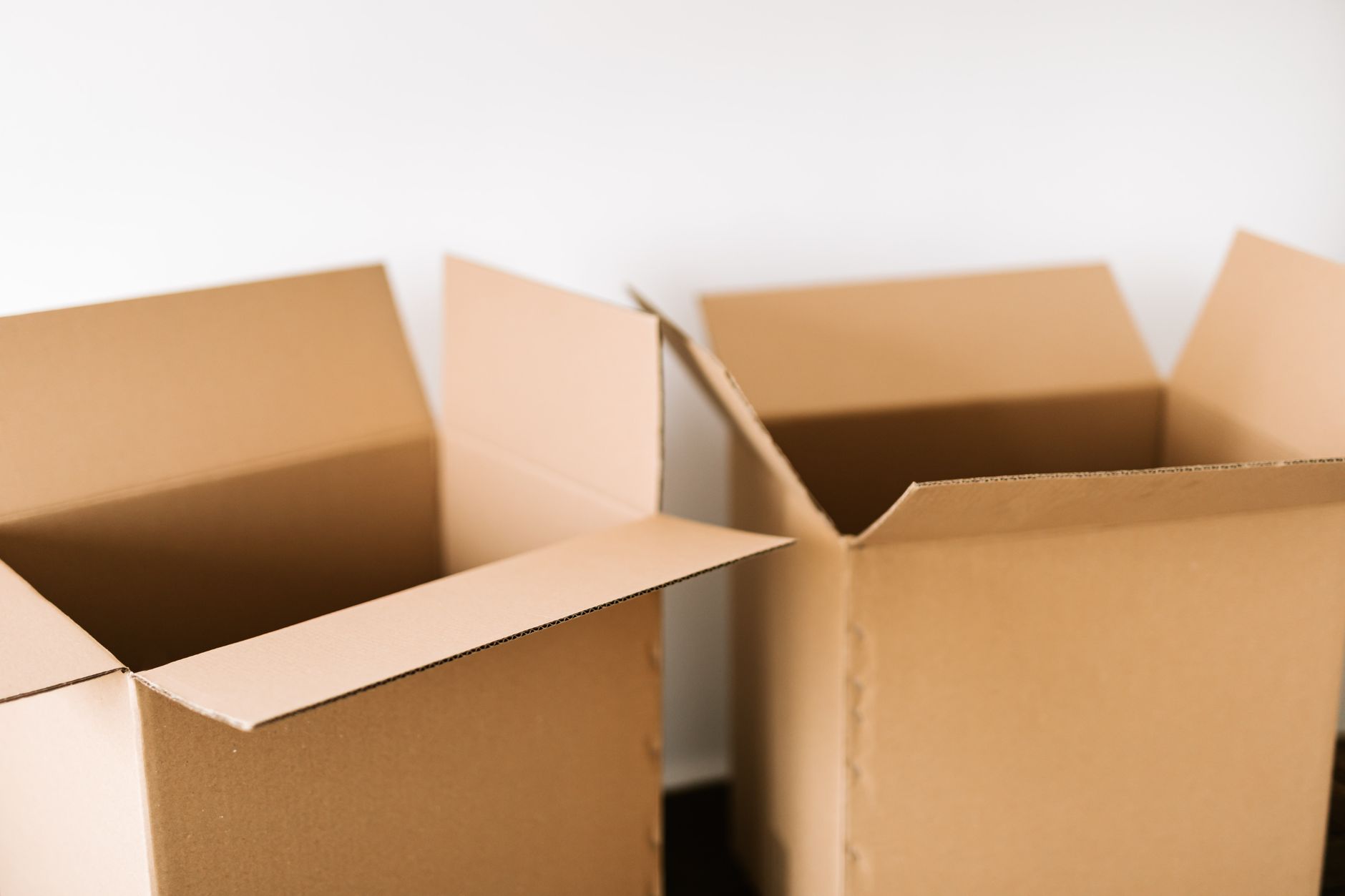 Open cardboard moving boxes ready to be filled