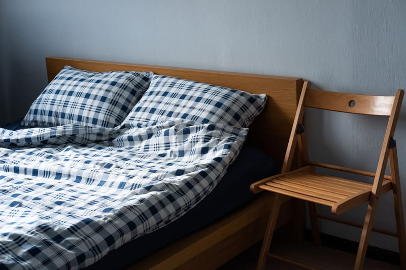 A double bed and mattress in a bedroom
