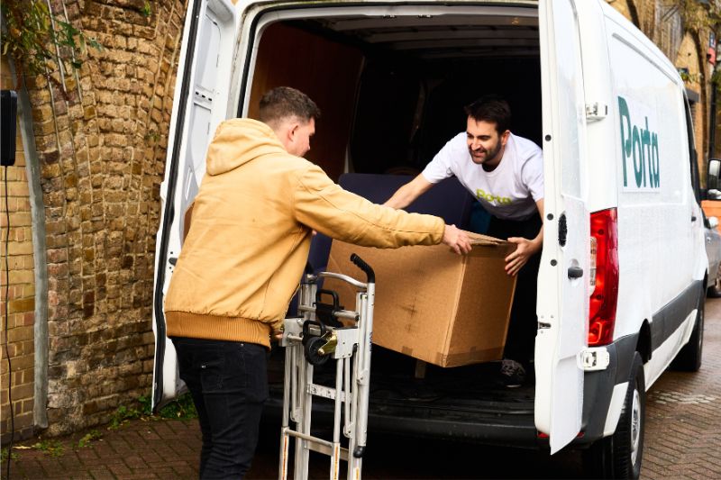 An independent driver loading a box into a Porta van