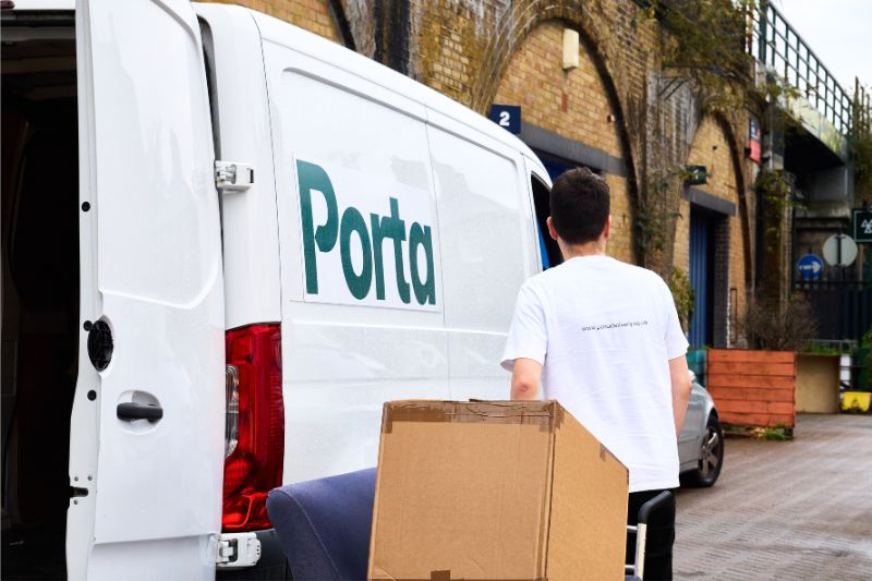 An independent driver moving an item on a sack truck